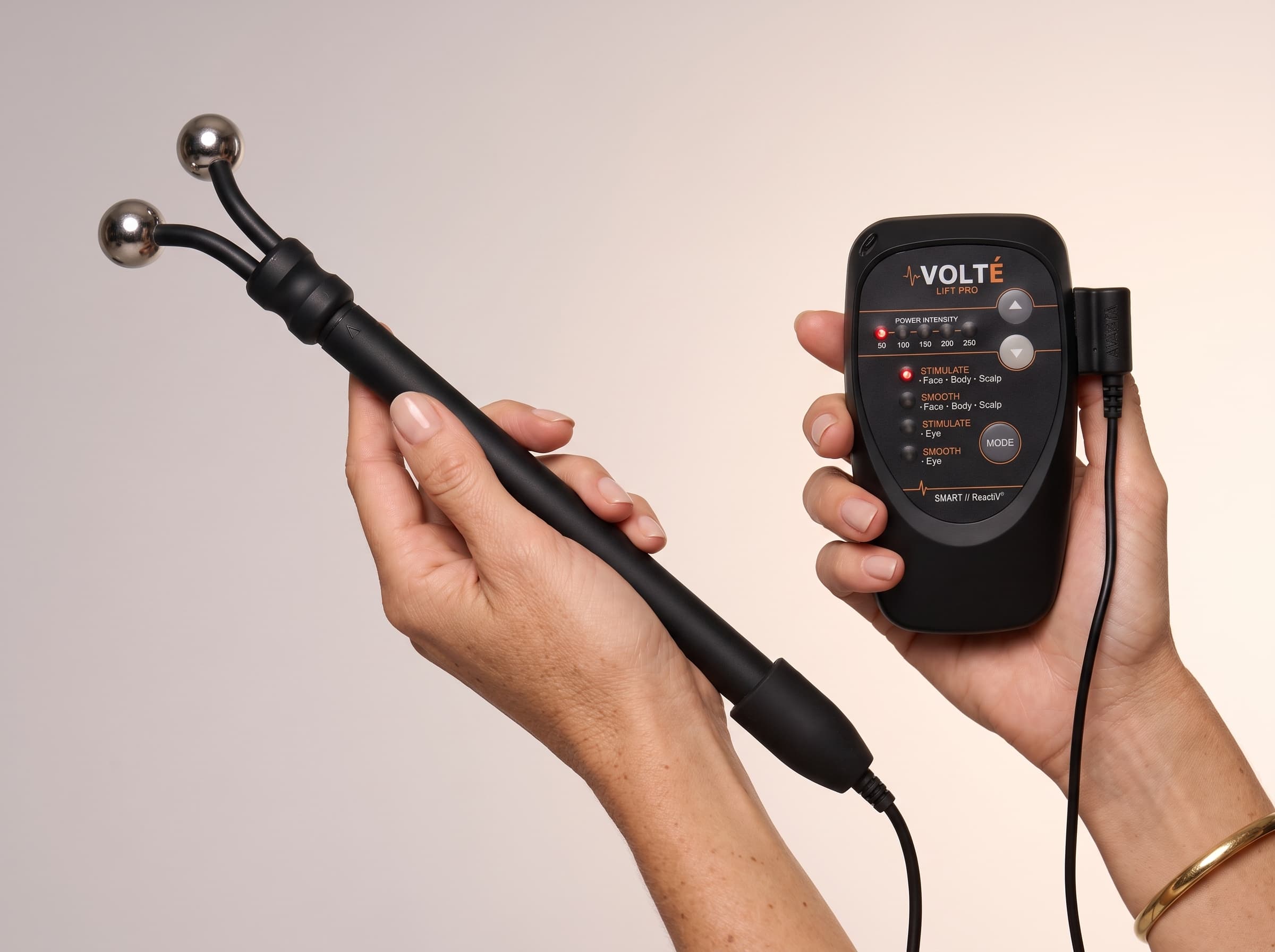 Woman holding the VOLTÉ Lift Pro and its wand